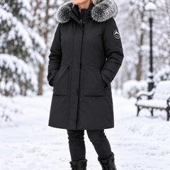 Arctic Shield Parka in black, worn by a woman in a snowy park